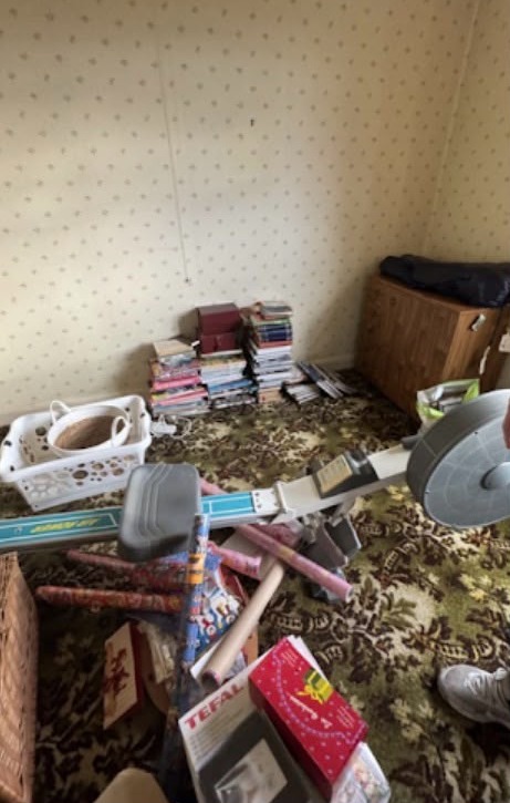 Bedroom full of belongings before HFC clearance